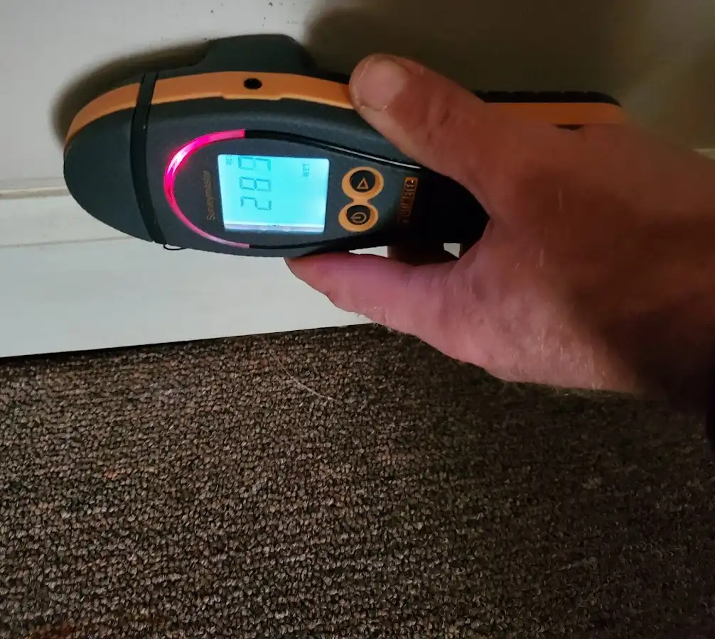 Moisture detection at baseboard during Storm Damage Restoration in Manchester